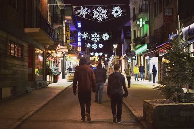 people walking at night on a street