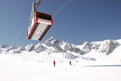 cable car crossing a ski piste