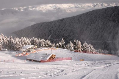 mountain hut covered in snow