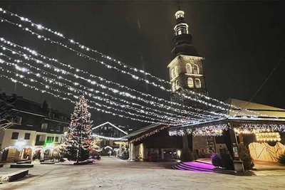 Light hanging across a church square in the French Alps