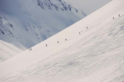 Skiers traversing an off-piste mountain slope