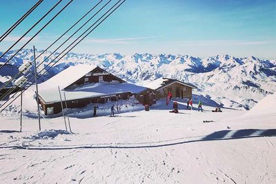 mountain hut covered in snow