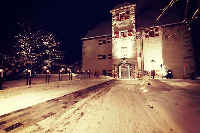 Castle in the snow at night