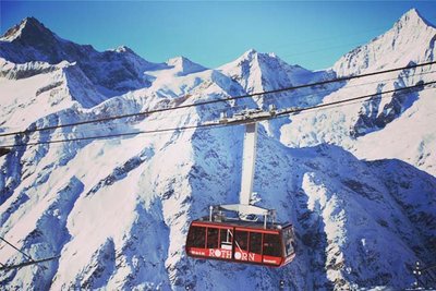 cable car in front of a mountain ridge