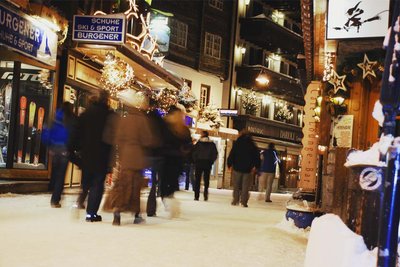 people walking at night on a street